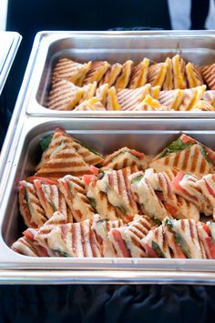 three trays filled with different types of sandwiches