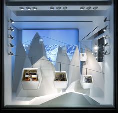 a display case with several items in it and some lights on the ceiling above them