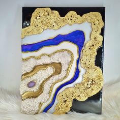 A natural piece of purple agate and crystals were used in this artwork. White, black, purple and gold are the colors used with a strong metallic sheen, gold leaf in the stripes which highlight the shine of the gold glitter. And for those who believe in the magic of precious stones Purple agate falls in the category of microcrystalline Quartz, popularly known as Chalcedony. The group has other stones, such as Carnelian, Onyx, Agate, and Jasper. The Chalcedony stones are present in cavities and cracks where previous volcanic activity happened. Humans started using purple agate back in Neolithic Sicily. Purple agate has unique properties and meaning. Visually the stone is quite alluring as it comprises purple shades and white bands. Its beauty is the reason why many artisans and collectors lo Unique Purple Geodes For Gifts, Unique Purple Geodes For Gift, Unique Handmade Gold Geodes, Resin Geode Wall Art, Geode Wall Art, Geode Wall, Geode Decor, Agate Art, Resin Geode