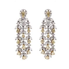 Handcrafted 18 karat gold chandelier earrings with pear cut fancy yellow diamonds 6.90 ct total. It is accented with round and marquise white diamonds 10.58 ct total. Diamonds are all natural in G-H Color Clarity VS. French / Omega clips. A truly breath taking piece inspired by Hollywood glamour and Art Deco style. Width: 1.8 cm Height: 5.8 cm Weight: 44.4 g Harry Winston Diamond Earrings, Chandelier Contemporary, Beautiful Diamond Earrings, Diamond Chandelier, Gold Chandelier Earrings, Platinum Earrings, Yellow Diamonds, Fancy Yellow Diamond, 18k Gold Earrings