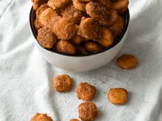 a bowl filled with fried food on top of a white cloth