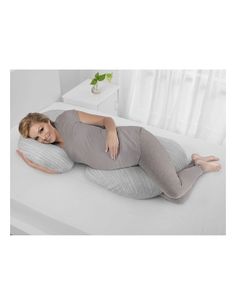 a woman laying on top of a bed with an inflatable pillow attached to it