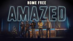 three men standing on stage in front of a sign that says, home free amazed