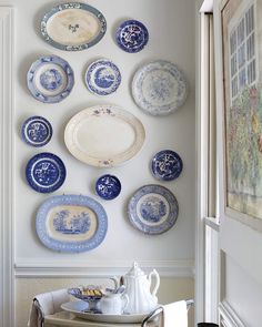 blue and white plates are arranged on the wall