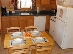 a kitchen with a table and chairs in it