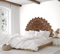 a bed with white sheets and pillows in a room