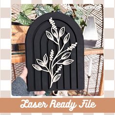 a person holding up a paper cut out of an arch with flowers on it and the words laser ready file