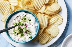 a white plate topped with chips and dip