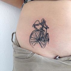 a woman with a bike tattoo on her stomach