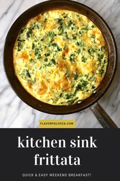 a skillet filled with spinach and cheese on top of a white marble counter