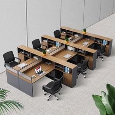 an office cubicle with desks and chairs in the middle, surrounded by plants