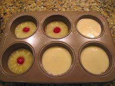 cupcakes in a muffin tin with pineapple topping