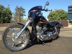 a black motorcycle parked on top of a parking lot