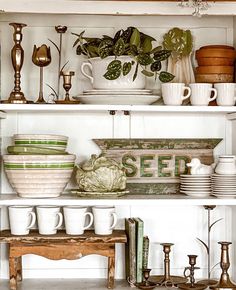 a shelf filled with lots of dishes and cups