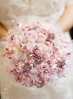 a bridal bouquet with pink roses and pearls