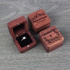 three wooden boxes with wedding rings in them