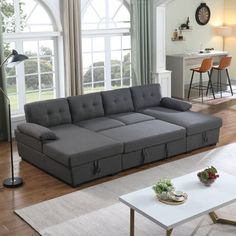 a living room filled with furniture and lots of windows