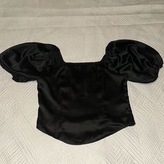 Black Satin Crop Top With Puffy Sleeve Never Worn Chic Black Fitted Crop Top, Fitted Black Padded Crop Top, Black Fitted Puff Sleeve Blouse, Black Short Sleeve Crop Top For Evening, Fitted Black Blouse For Summer, Black Puff Sleeve Stretch Top, Black Stretch Crop Top Blouse, Black Padded Blouse Crop Top, Elegant Black Short Sleeve Crop Top