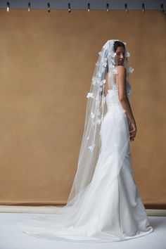 a woman in a white wedding dress and veil