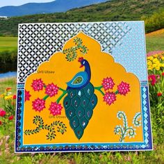 a sign in the grass with flowers and a bird on it