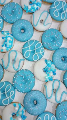 blue and white decorated doughnuts in a box