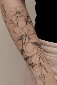 a woman's arm with flowers on it