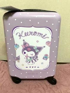 a purple suitcase sitting on top of a floor next to a pink rug and wall