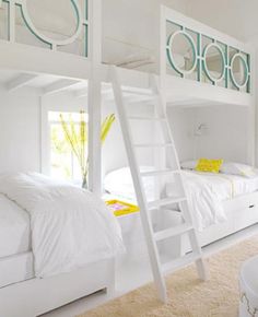 a bedroom with bunk beds and white furniture