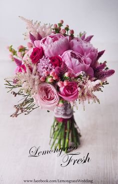 a vase filled with pink flowers on top of a table