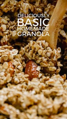 a close up of granola in a bowl with a wooden spoon