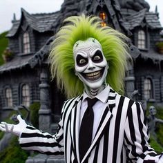 a creepy clown dressed in black and white striped suit with green hair, holding out his arms