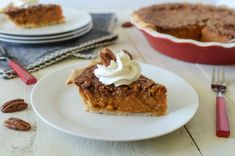 a slice of pecan pie on a plate next to a fork and bowl of pecans