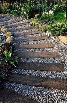 a stone path in the middle of a garden