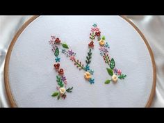 the letter n is made up of flowers and leaves