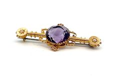 Pressed and assembled amethyst and pearl brooch. The brooch measures 50mm x 20.3mm and has a 13mm round cut amethyst in a multi claw mount at the centre and a half seed pearl star set at each end. The brooch is Hallmarked Birmingham 1916 and 15 and .625. The brooch weighs 5.3gms.  E9607 Antique Cabochon Brooch For Formal Occasions, Antique Cabochon Brooch For Formal Wear, Vintage Gemstone Round Brooches, Art Deco Round Brooches For Formal Occasions, Elegant Amethyst Brooches For Wedding, Antique Hallmarked Purple Brooches, Antique Purple Hallmarked Brooches, Vintage Gemstone Brooches For Formal Occasions, Victorian Round Brooches For Formal Occasions