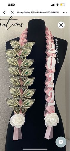 a black mannequin with money tied to it's sides and pink ribbon around the neck