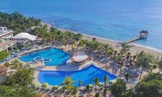 an aerial view of a resort pool and beach