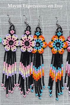 four pairs of beaded earrings hanging from hooks on a piece of fabric with text overlay