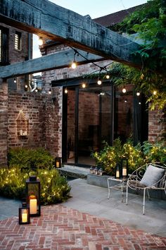 an outdoor patio with brick walls and lights