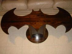 a wooden bat shaped mirror sitting on top of a tile floor