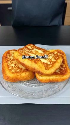 three pieces of bread sitting on top of a glass plate