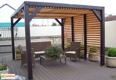 an outdoor covered patio area with chairs and plants on the deck, next to a hot tub