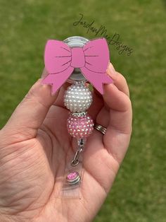 🎀 Face topper only- means you will only receive the pink bow top acrylic. No reel will come with it. You can glue it to your own reel or pop socket.  Such a beautiful HIGH QUALITY pink bow Badge Reel. This peony retractable badge holder is the best choice for ALL.  What a fun accessory to your scrubs, shirt pocket, belt loop, lanyard and more.  They make super fun and useful gifts for any person in any profession.  A great gift choice for nurses, medical staff, office staff, and anyone who is r Pink Pop Socket, Cheap Playful Pink Badge Holders, Pink Bow Top, Beaded Badge Reel, Coquette Ribbon, Useful Gifts, Office Staff, Medical Staff, Shirt Pocket