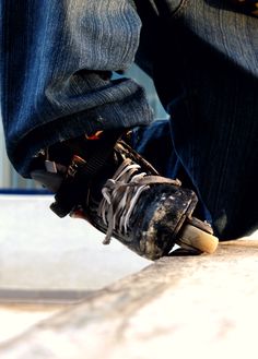 a person riding a skateboard on top of cement