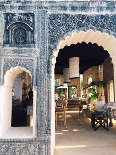 an archway leading into a living room filled with furniture