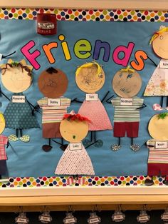 a bulletin board decorated with children's clothes and the words friends on it in front of them