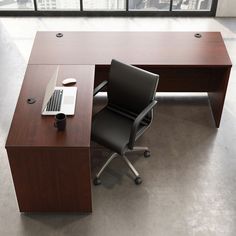 an office desk with a laptop on it and a chair in front of the desk