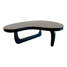 a black and white table with a curved design on it's top, against a white background