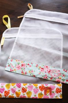 two pieces of fabric sitting on top of a wooden table