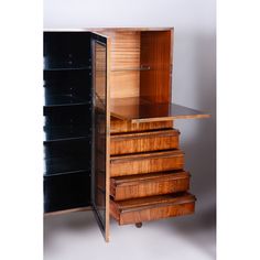 a wooden cabinet with five drawers on wheels